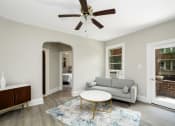 Thumbnail 3 of 15 - a living room with a couch coffee table and a ceiling fan