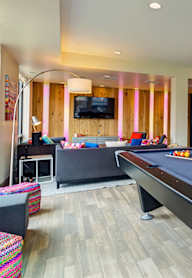 a game room with a pool table and a tv