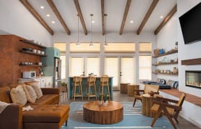 a living room with white couches and a coffee table with a vase of flowers and