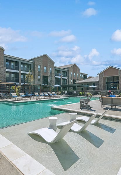 Community Swimming Pool with Pool Furniture at Alta 3Eighty Apartments located in Aubrey, TX-POOL1.