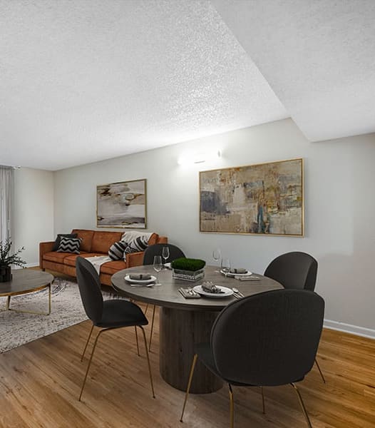 a living room with a couch and a table with chairs