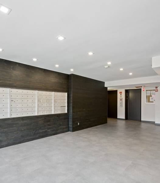 a room with a wall of lockers