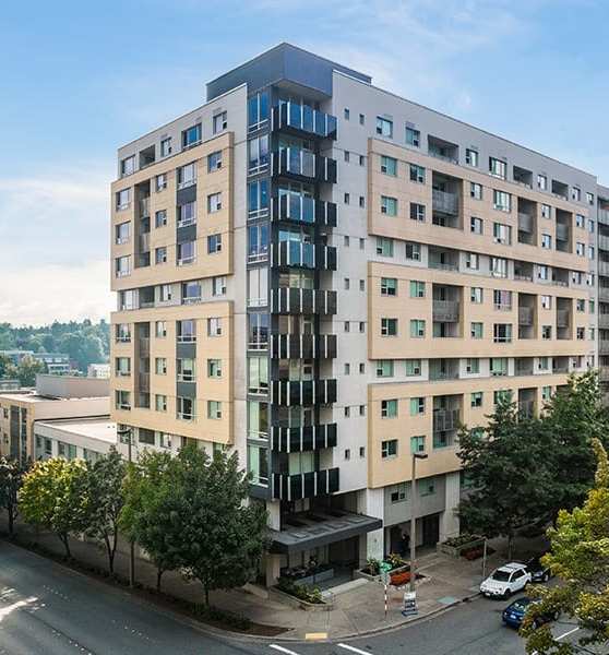 A parking lot with cars and a building with a sign that says Mendocino Farms.