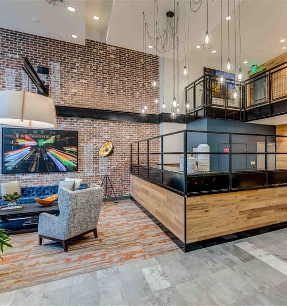 a lobby with a couch chairs and a table