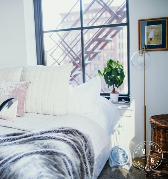 a bedroom with a bed and a large window at The Equitable Building, Des Moines, IA, 50309