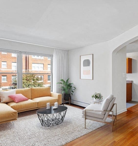a living room with a couch and a table and a window
