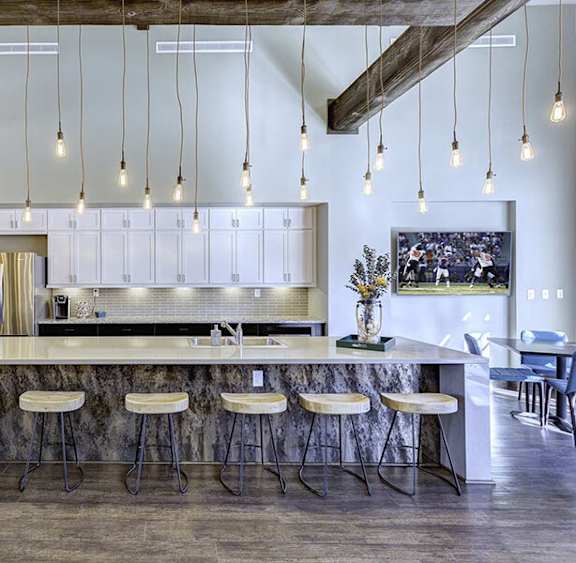 a kitchen with a long island with bar stools
