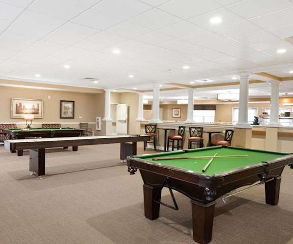 A room with a pool table and a billiard table.