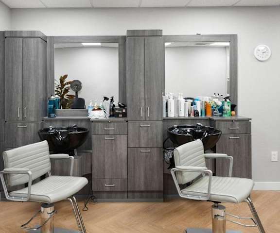 A salon with two chairs and a vanity table.