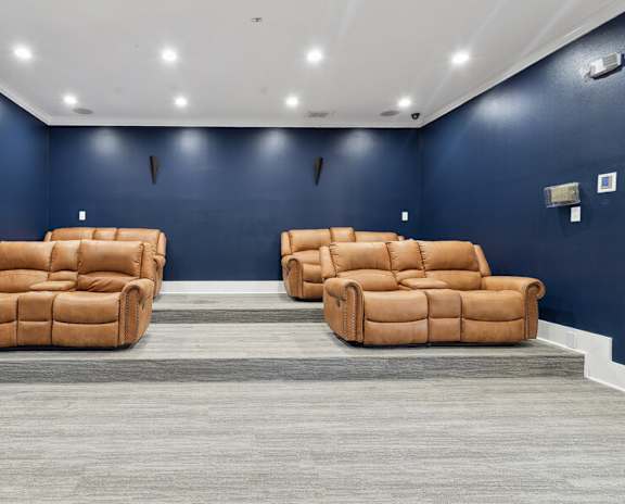 two couches in a room with blue walls and a rug