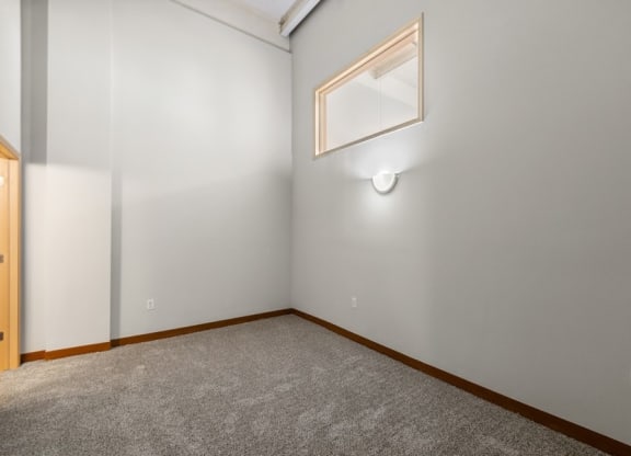 the bedroom of an empty house with a rug on the floor