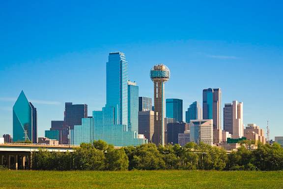 A city skyline with a tall tower in the center.
