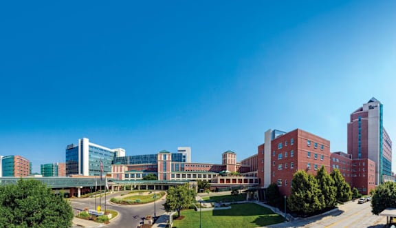 A hospital complex with a mix of modern and older buildings.