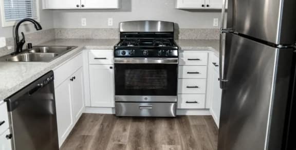 a kitchen with wooden cabinets and a stove top oven