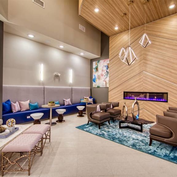a lobby with couches chairs and a fireplace