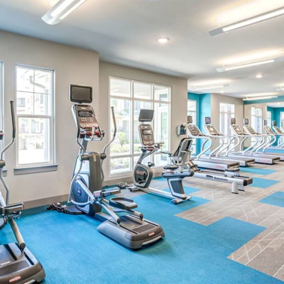 a room filled with lots of cardio equipment