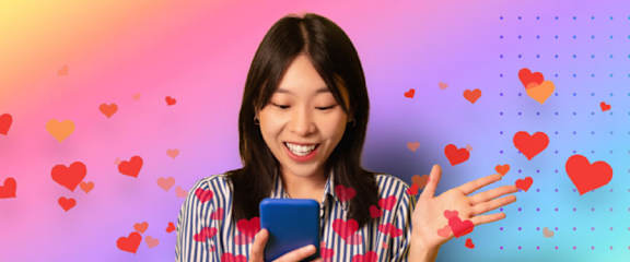A person is holding a phone and appears to be sending a message.