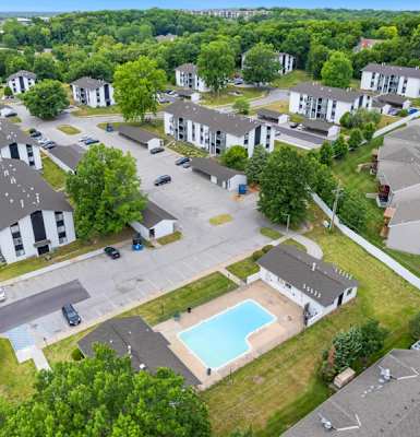 an aerial view of a neighborhood with houses and a swimming pool