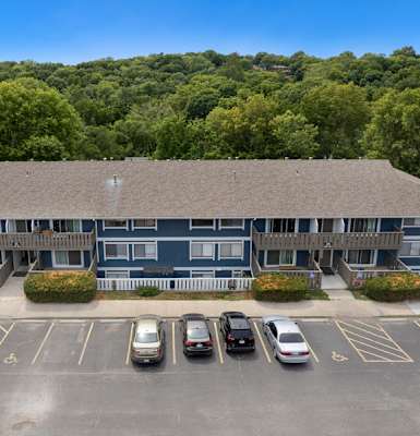 an aerial view of an apartment building with a parking lot