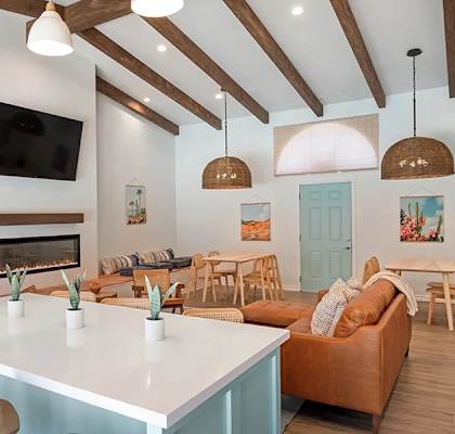a living room with a white table and a fireplace