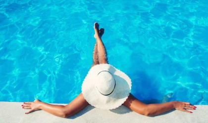 Woman Wearing Hat Relaxing in Pool