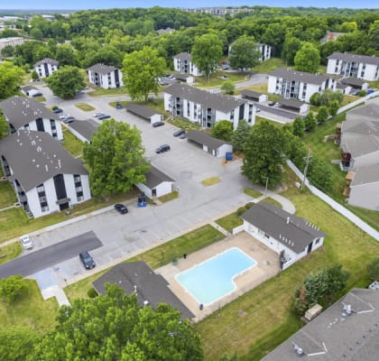 an aerial view of a neighborhood with houses and a swimming pool