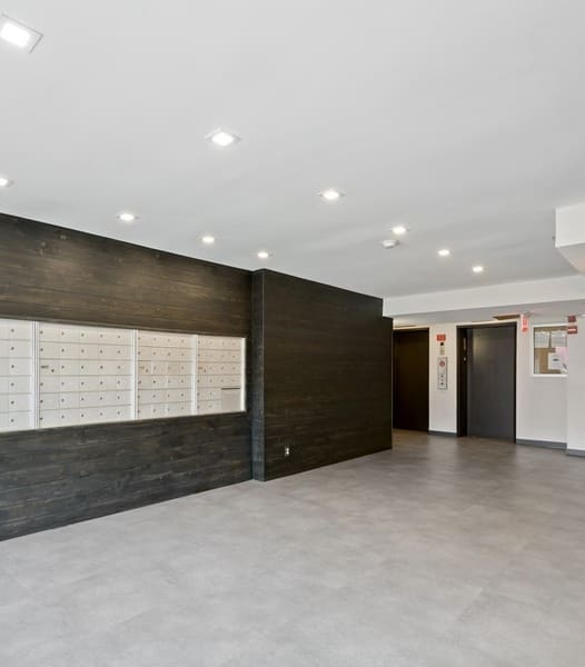 a room with a wall of lockers