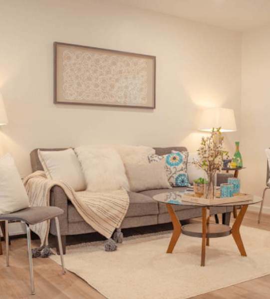 a bedroom with a bed and a kitchen and a living room