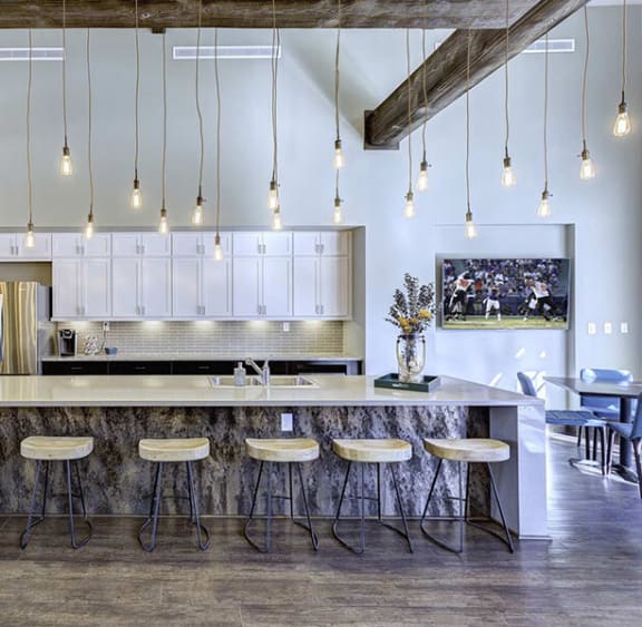 a kitchen with a long island with bar stools