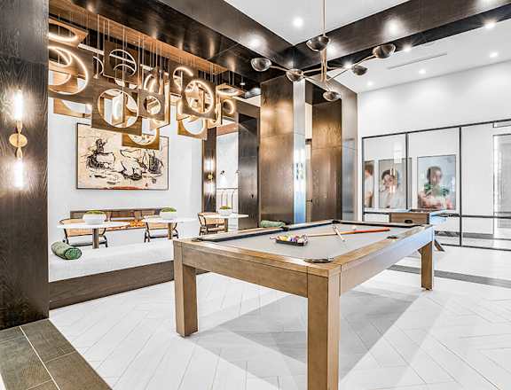 Community Clubhouse with Game Tables at Ovation at Galatyn Park Apartments located in Richardson, TX.