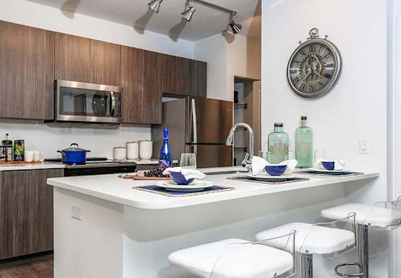 a kitchen with a bar and a clock on the wall at Shingle Creek, Kissimmee, Florida