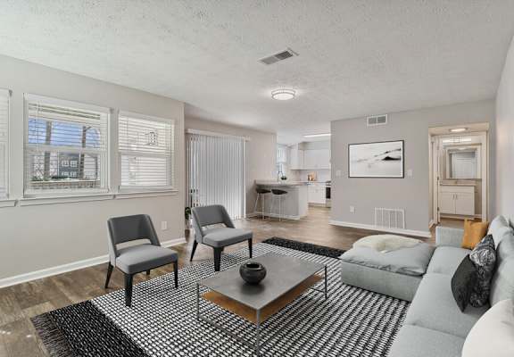 a living room with a couch and two chairs