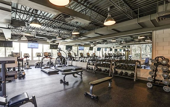 the gym has a wall of dumbbells and exercise equipment at The Boulevard, Roeland Park, KS, 66205