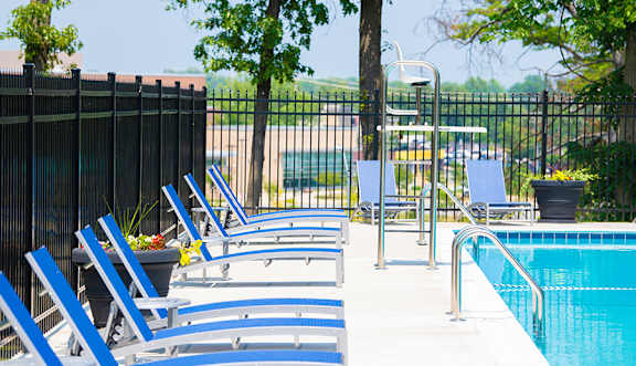 a large swimming pool with chairs in it at Somerset at Towson Apartments, Towson, MD, 21204
