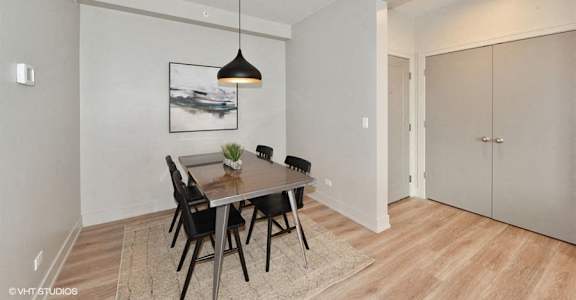 a dining room with a wooden table and chairs