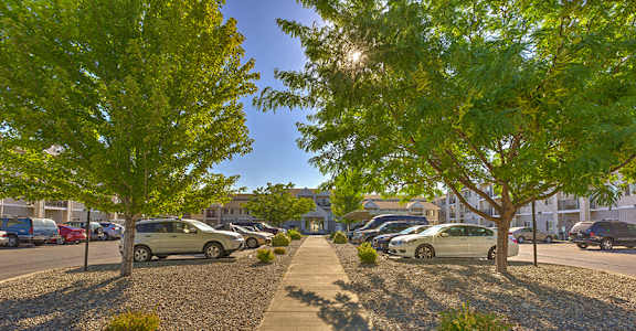 A parking lot with cars and trees at VINTAGE AT RICHLAND Apartments, Washington, 99352