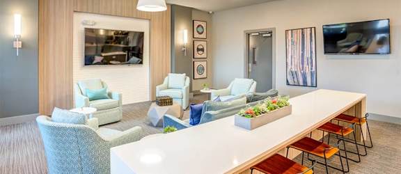 a living room filled with furniture and a large white table