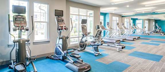 a room filled with lots of cardio equipment