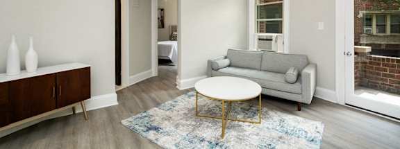 a living room with a couch coffee table and a ceiling fan