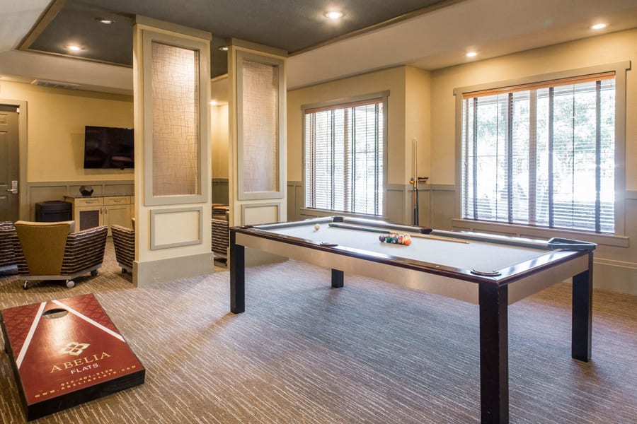 Abelia Flats game lounge with pool table and cornhole - Austin, TX