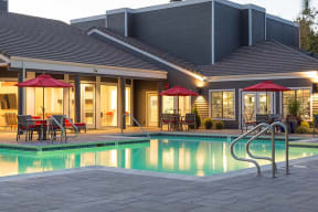 Evening pool view with seating  l Kirker Creek Apartments