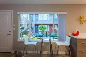Dining table by window l The Parc at Pruneyard Apartments