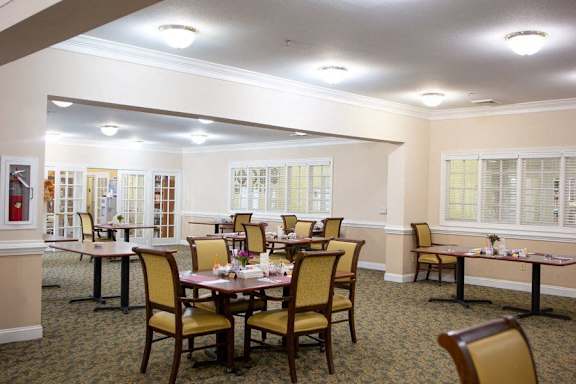 a dining area with tables and chairs in a room