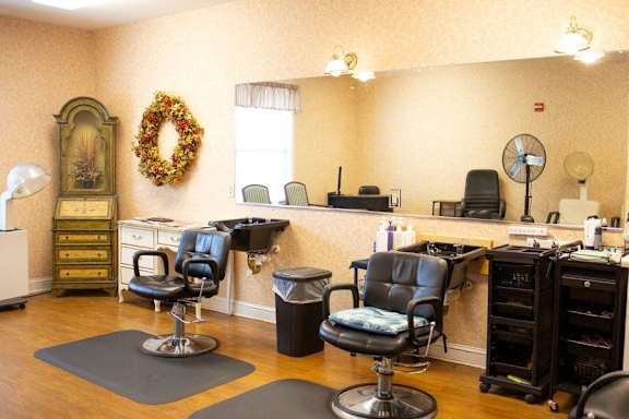 a barbershop with chairs and a counter in a nail salon