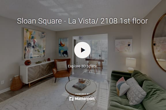 A living room with a couch, chair, and coffee table is displayed on a screen.