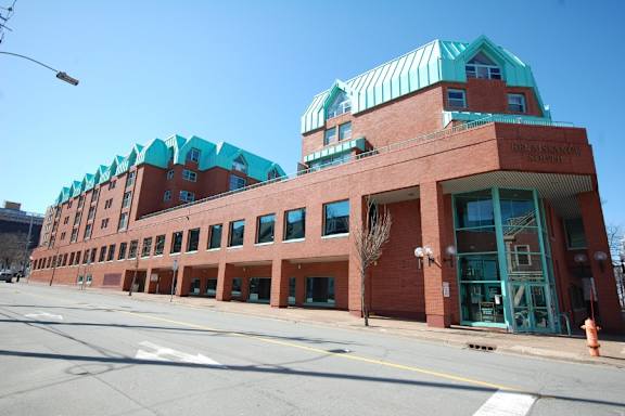 A red building with a green roof and a sign that says "Renaissance".