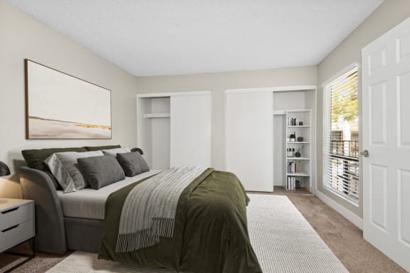 Model apartment bedroom with a large bed and a large window at Villages at Metro Center, Phoenix, Arizona, 85051