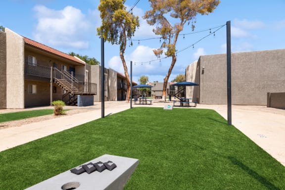 community cornhole area on artificial turf at Villages at Metro Center, Arizona, 85051