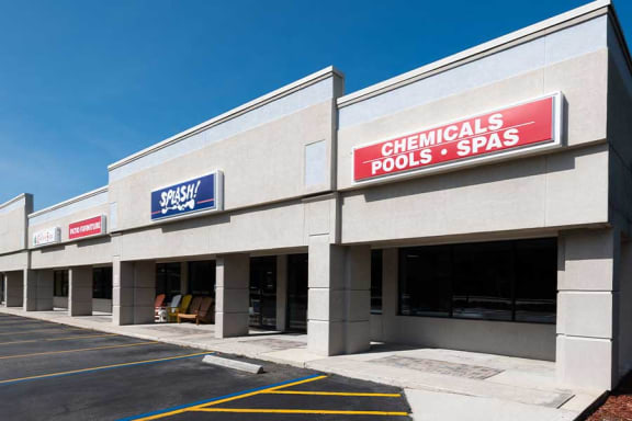 a large building with a sign that reads chemicals pools and spa