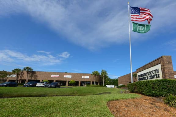 a flagpole with an american flag and a mexican flag in front of a